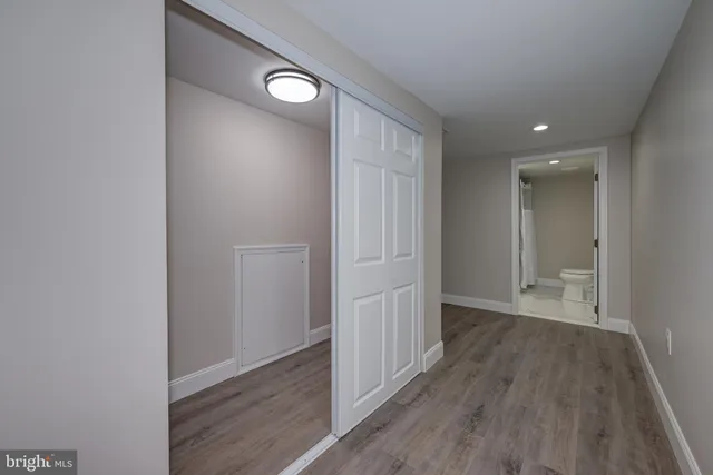 a view of hallway with wooden floor