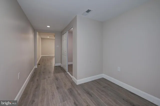 a view of a hallway with wooden floor