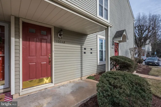 a view of a house with a small yard and wooden fence