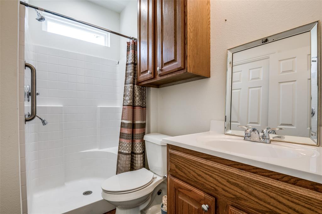 2412 Colquitt Road Terrell, TX 75160 - Photo 17 of 24 a bathroom with a sink a toilet and shower