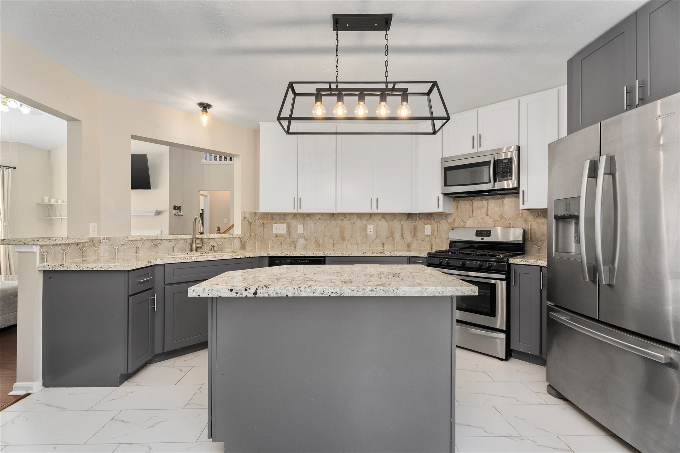 a kitchen with stainless steel appliances granite countertop a sink stove and refrigerator