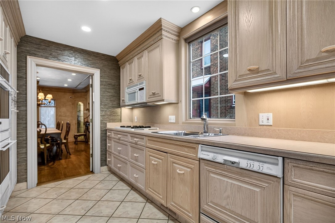 3498 Bainbridge Road Cleveland Heights, OH 44118 - Photo 16 of 50 Kitchen with dishwasher, light countertops, a chandelier, light tile patterned floors, and white microwave