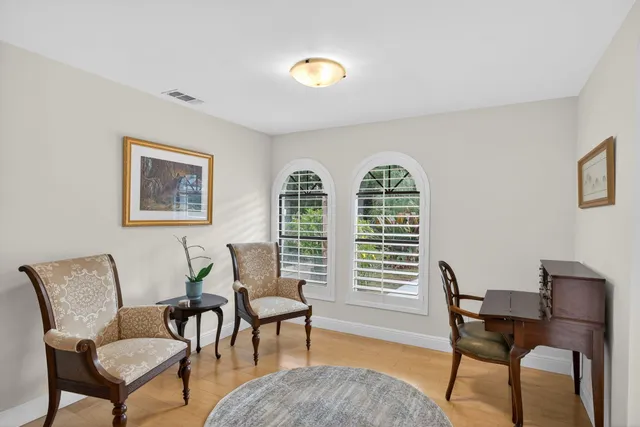 a view of a livingroom with furniture window and wooden floor