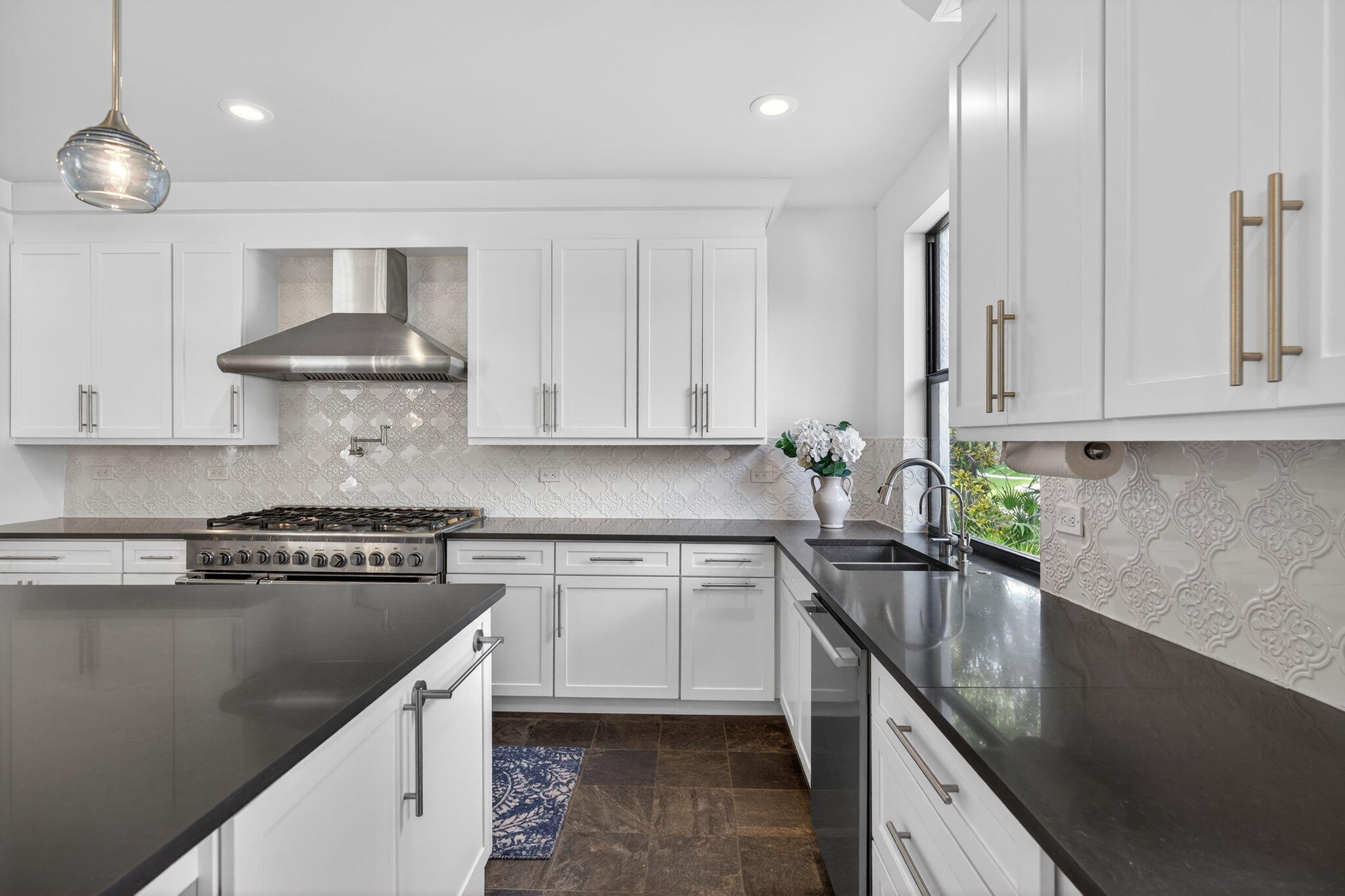 1488 Southeast Colony Way Jupiter, FL 33478 - Photo 17 of 51 a kitchen with stainless steel appliances granite countertop a sink a stove and a refrigerator