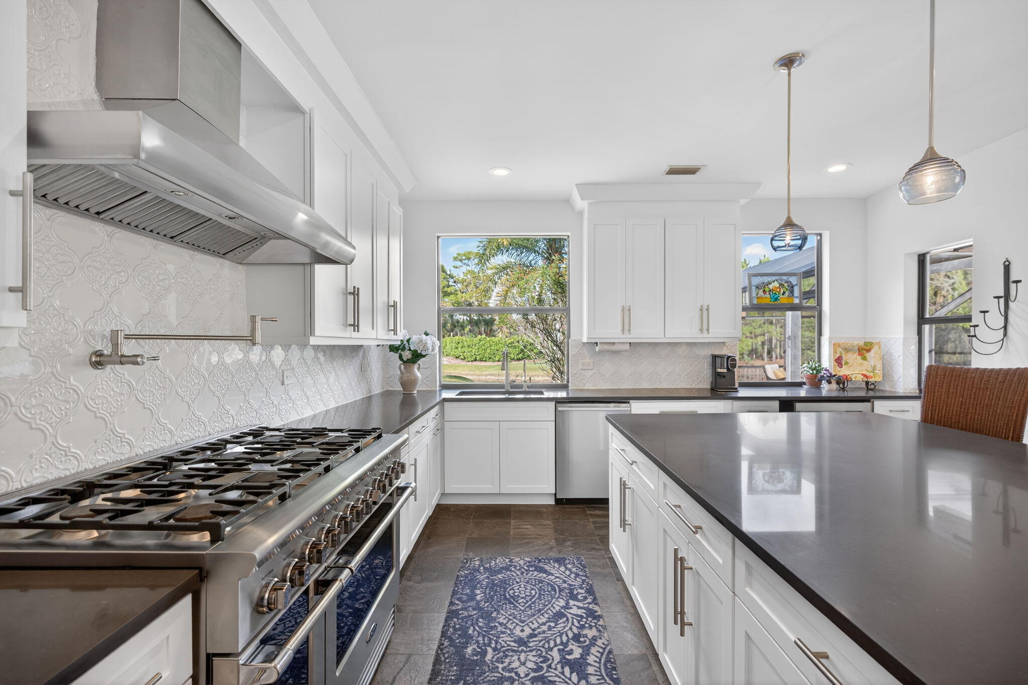 1488 Southeast Colony Way Jupiter, FL 33478 - Photo 19 of 51 a kitchen with sink stove and cabinets