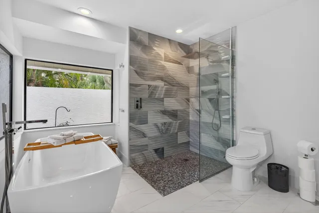 a spacious bathroom with a granite countertop sink and a mirror