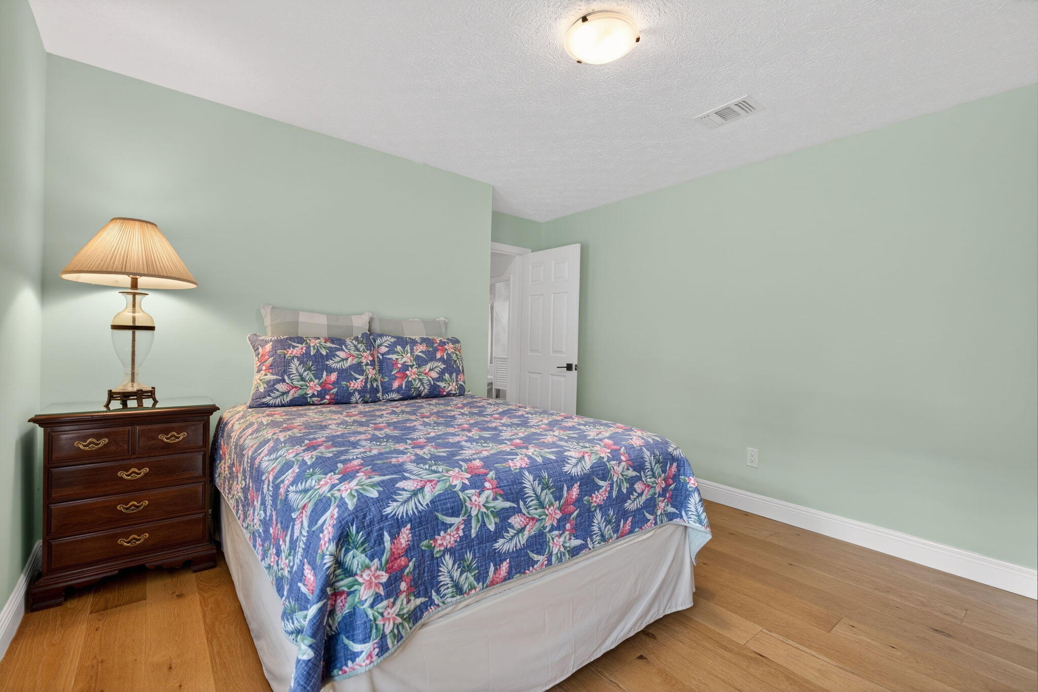 1488 Southeast Colony Way Jupiter, FL 33478 - Photo 28 of 51 a bedroom with a bed and a lamp