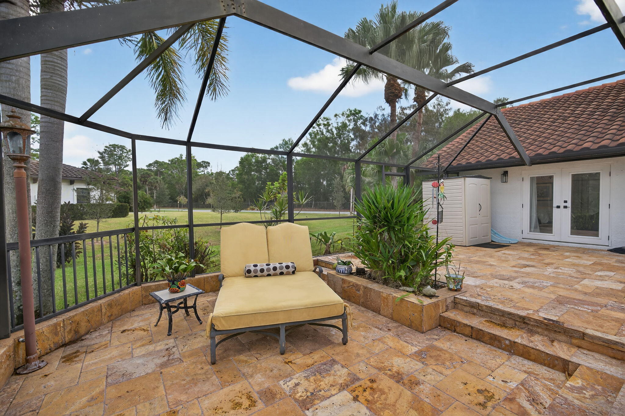 1488 Southeast Colony Way Jupiter, FL 33478 - Photo 35 of 51 a view of a patio with a table chairs and a backyard