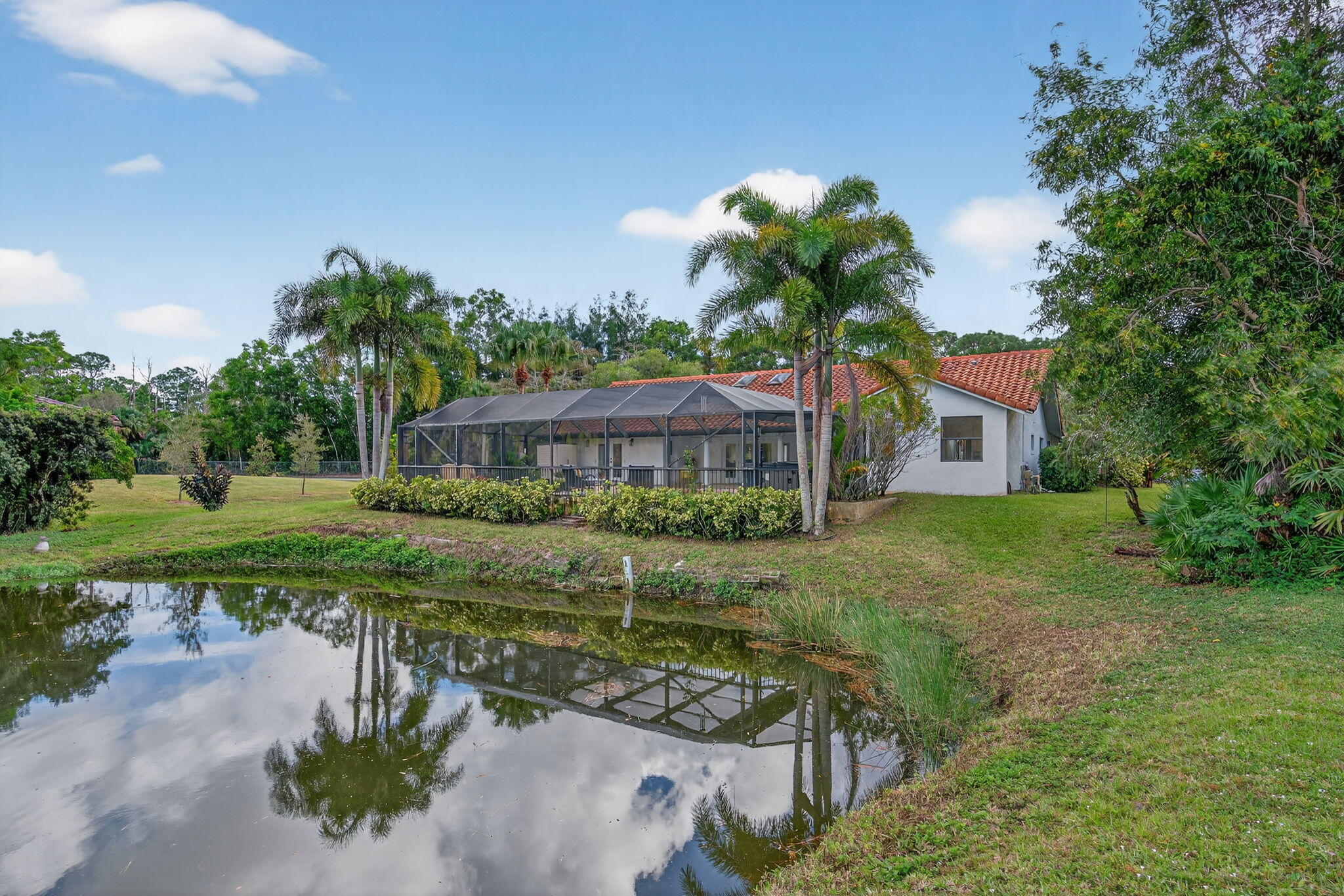 1488 Southeast Colony Way Jupiter, FL 33478 - Photo 39 of 51 a front view of a house with garden