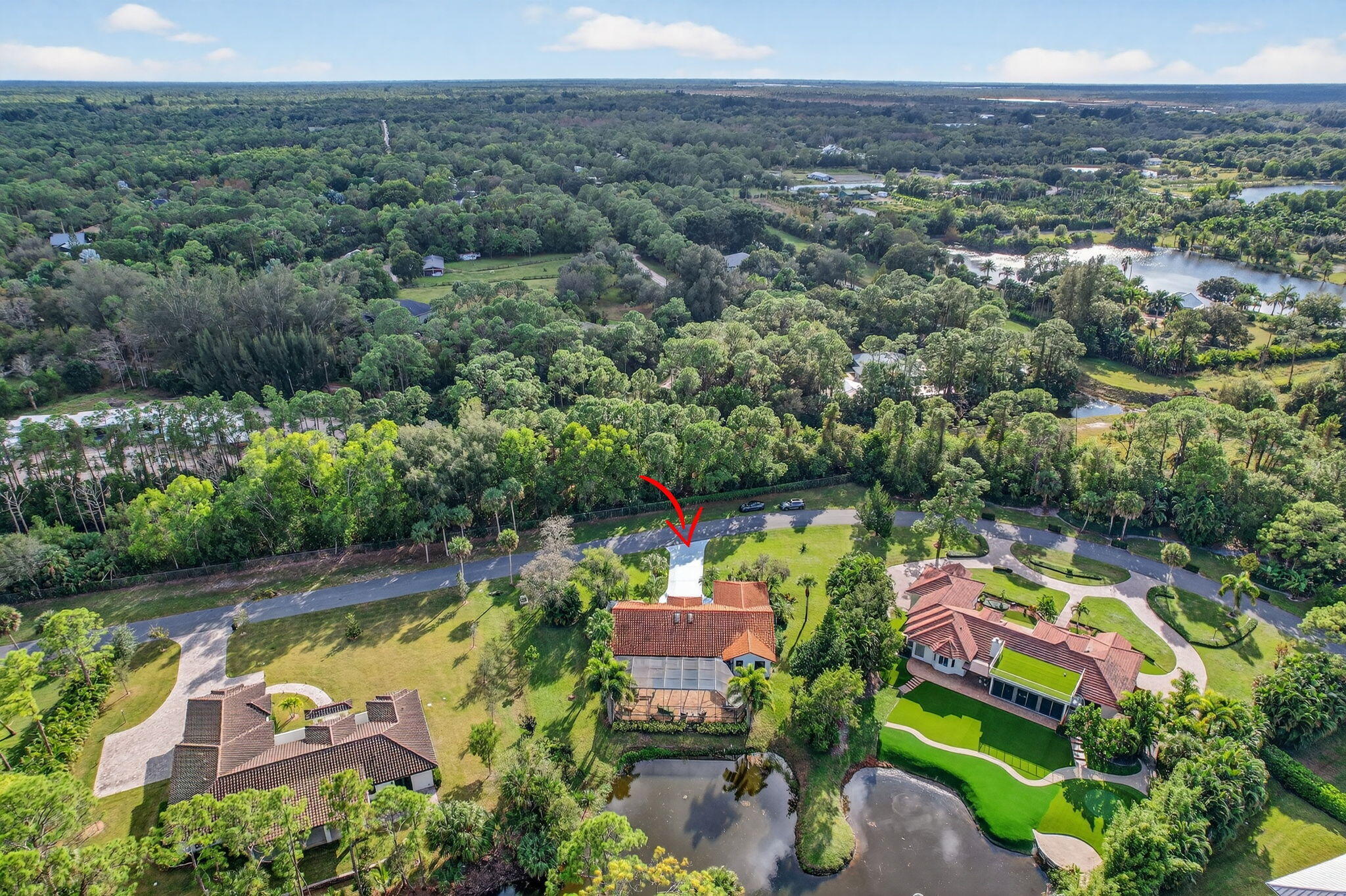 1488 Southeast Colony Way Jupiter, FL 33478 - Photo 48 of 51 an aerial view of residential houses with outdoor space and swimming pool