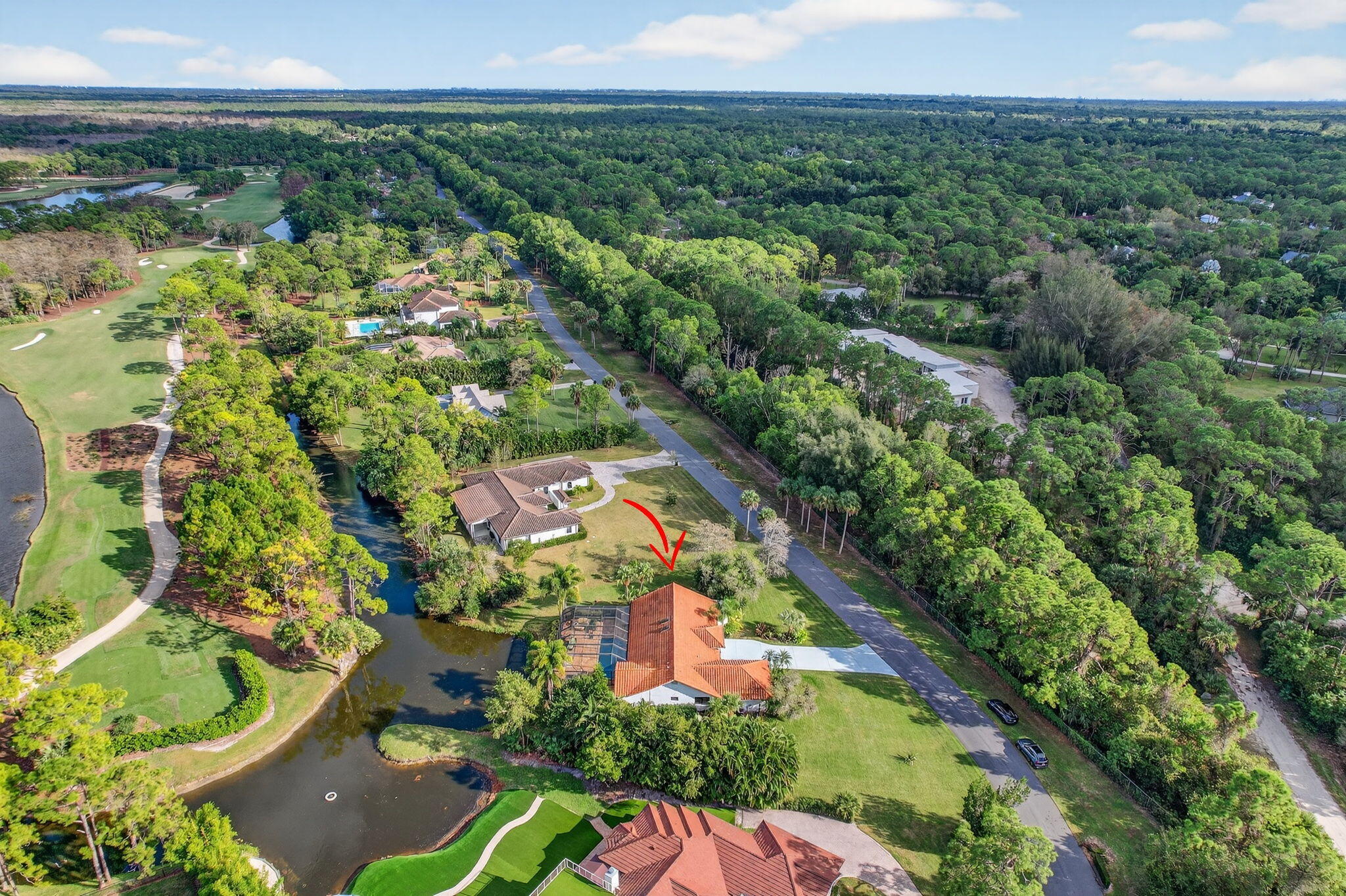 1488 Southeast Colony Way Jupiter, FL 33478 - Photo 49 of 51 an aerial view of a residential houses with outdoor space and trees all around
