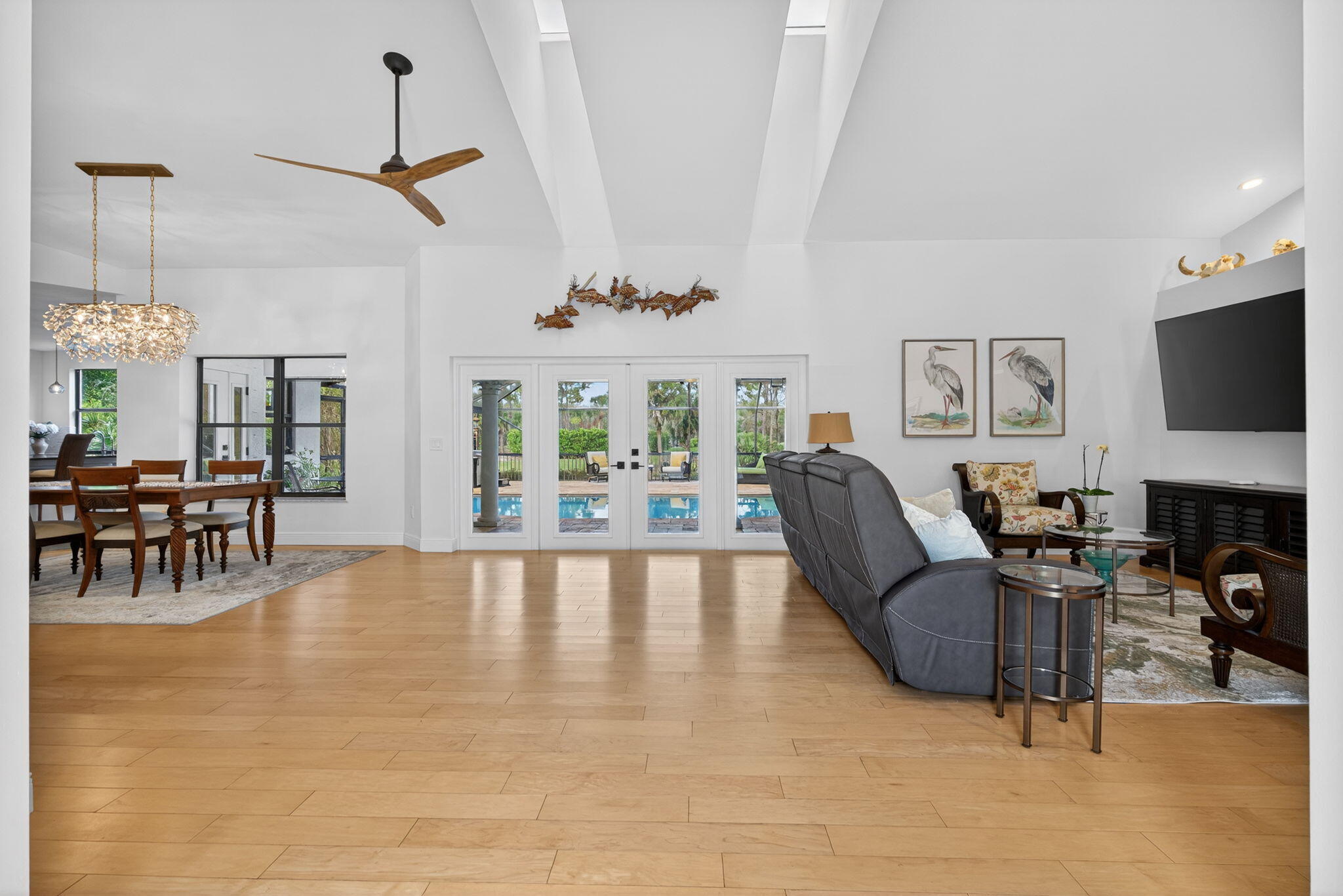 1488 Southeast Colony Way Jupiter, FL 33478 - Photo 8 of 51 a living room with furniture a fireplace and a flat screen tv