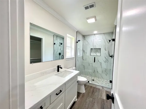 a bathroom with a double vanity sink mirror double and shower