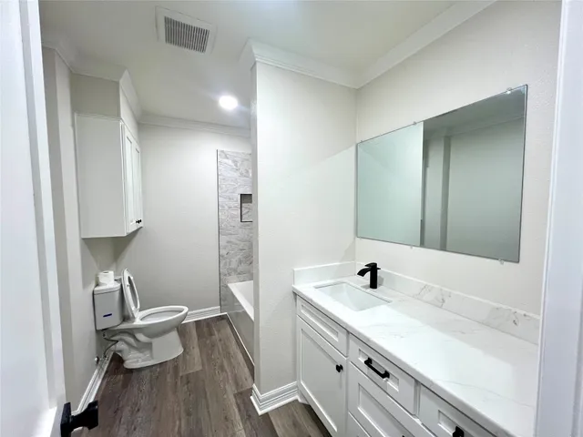 a bathroom with a sink a toilet and a mirror