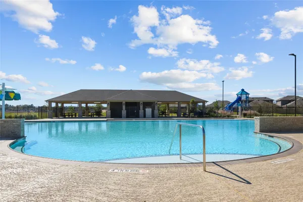 a view of a swimming pool with a yard