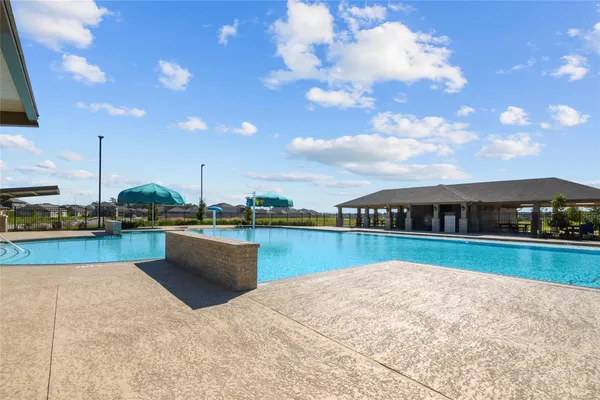 a view of swimming pool with outdoor seating