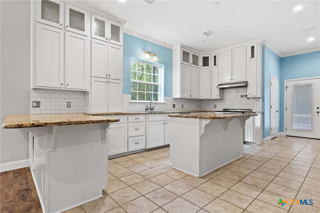 275 Woodruff Road Waco, TX 76705 - Photo 2 of 45 a kitchen with stainless steel appliances granite countertop a stove a sink and a microwave