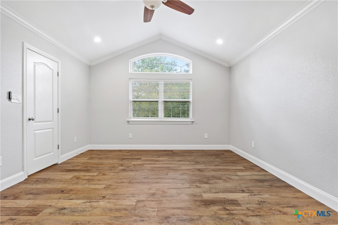 275 Woodruff Road Waco, TX 76705 - Photo 25 of 45 an empty room with wooden floor cabinet and windows
