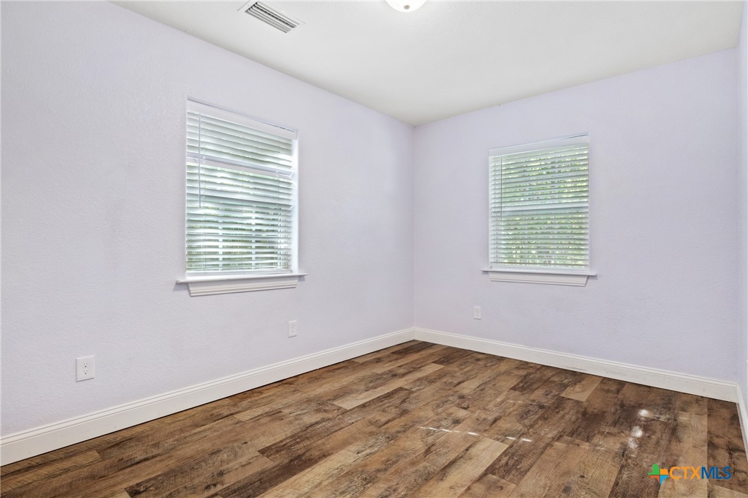 275 Woodruff Road Waco, TX 76705 - Photo 39 of 45 a view of an empty room with wooden floor and a window
