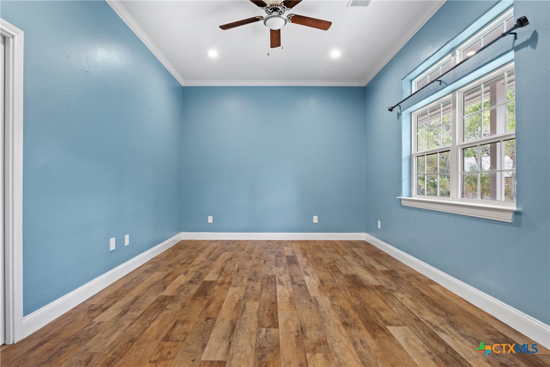 275 Woodruff Road Waco, TX 76705 - Photo 10 of 45 wooden floor in an empty room with a window