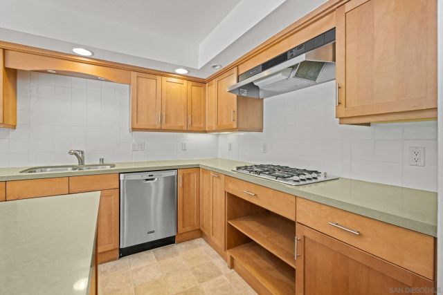 a kitchen with stainless steel appliances granite countertop a sink stove and cabinets