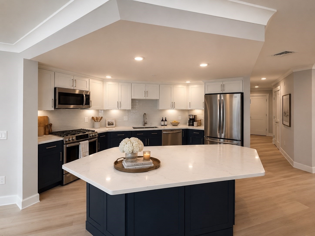 269 Main Street, Unit 2006 Reading, MA 01867 - Photo 2 of 10 a kitchen with a center island and stainless steel appliances