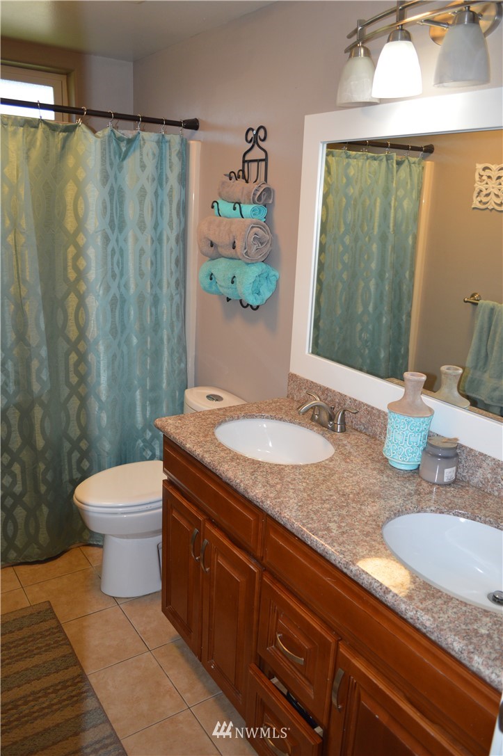 6760 Old Guide Road Lynden, WA 98264 - Photo 22 of 37 a bathroom with a granite countertop sink toilet and shower