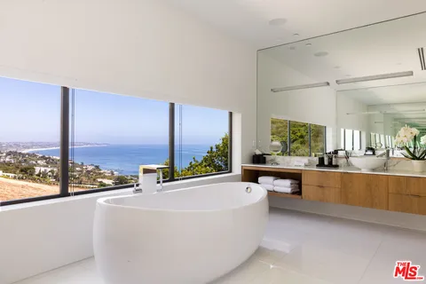 a bathroom with a tub shower and a sink