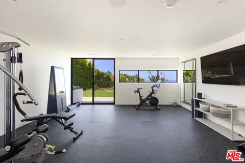 a bedroom with a large bed and a night stand