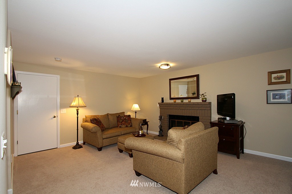 24200 16th Place Southeast Bothell, WA 98021 - Photo 5 of 14 a living room with furniture a fireplace and a flat screen tv