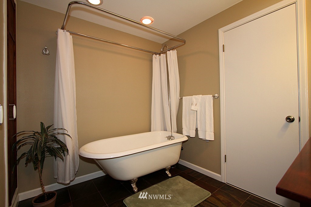 24200 16th Place Southeast Bothell, WA 98021 - Photo 8 of 14 a bathroom with a toilet and a shower curtain