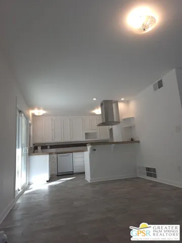 a kitchen with stainless steel appliances wooden cabinets and granite counter tops