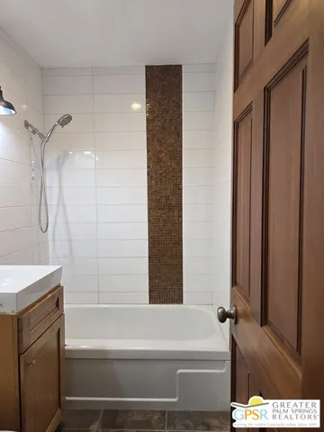 a bathroom with a bathtub and a shower