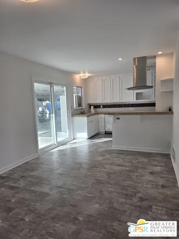 a kitchen with stainless steel appliances a refrigerator sink and microwave
