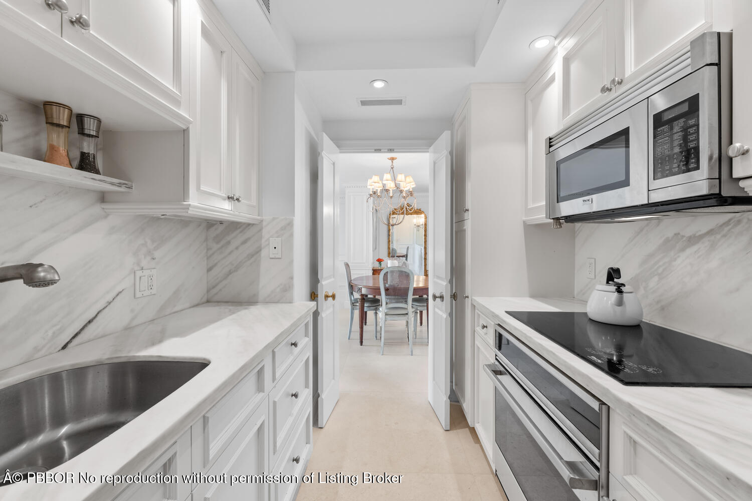 354 Chilean Avenue, Unit 6E Palm Beach, FL 33480 - Photo 8 of 16 a kitchen with stainless steel appliances granite countertop a sink and dishwasher a stove top oven with wooden floor