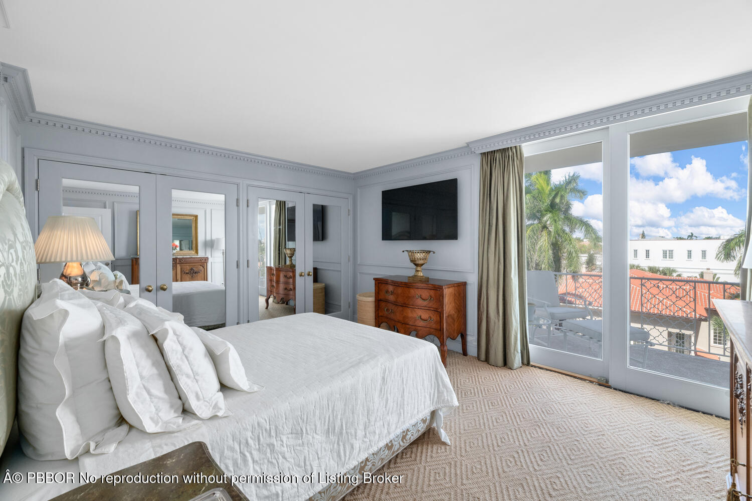 354 Chilean Avenue, Unit 6E Palm Beach, FL 33480 - Photo 9 of 16 a bedroom with a large bed and a flat tv screen