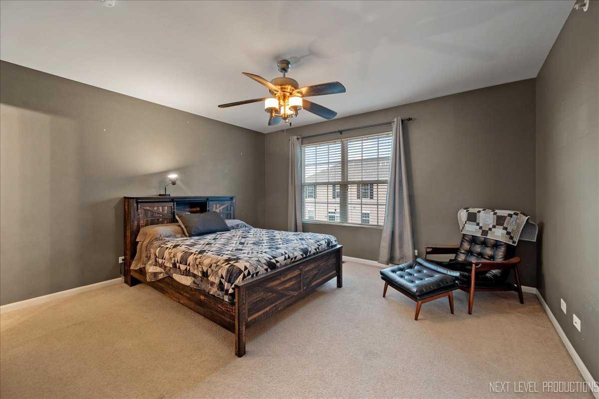 3765 Bailey Road Yorkville, IL 60560 - Photo 11 of 27 a bedroom with a bed and a chandelier