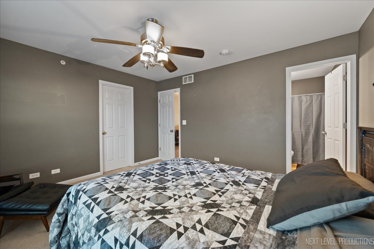 3765 Bailey Road Yorkville, IL 60560 - Photo 12 of 27 a bedroom with a bed and a chandelier