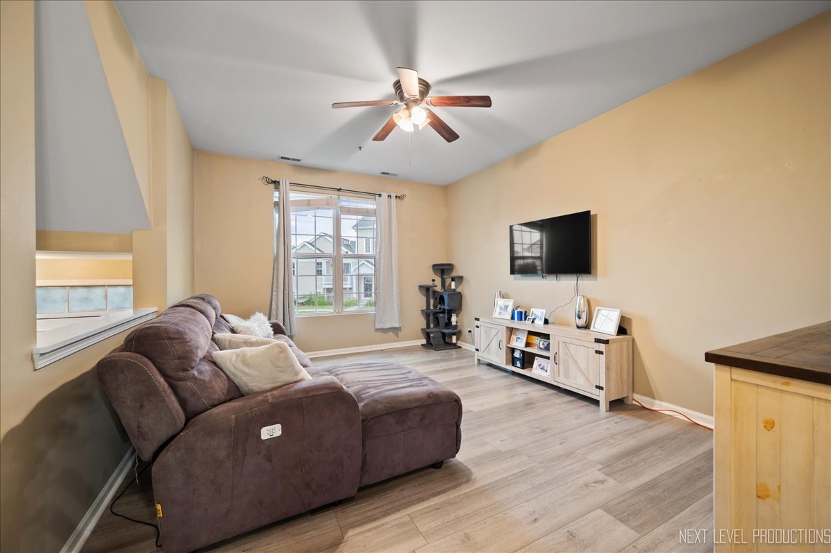 3765 Bailey Road Yorkville, IL 60560 - Photo 4 of 27 a living room with furniture and a flat screen tv