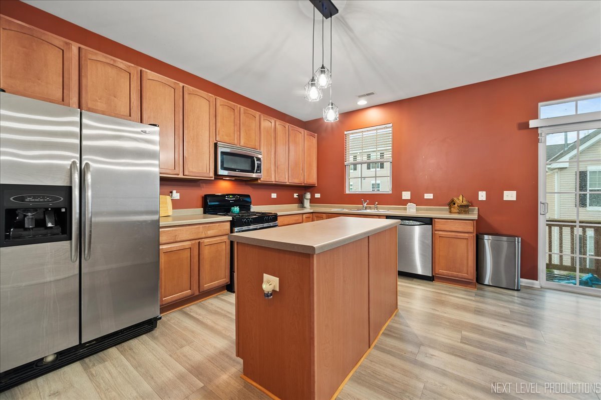 3765 Bailey Road Yorkville, IL 60560 - Photo 6 of 27 a kitchen with stainless steel appliances granite countertop a stove top oven a refrigerator a sink and dishwasher