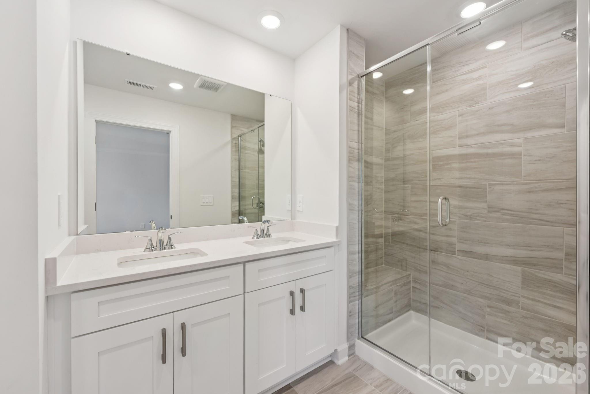 445 Markridge Loop Fort Mill, SC 29708 - Photo 12 of 13 a bathroom with a shower sink and mirror