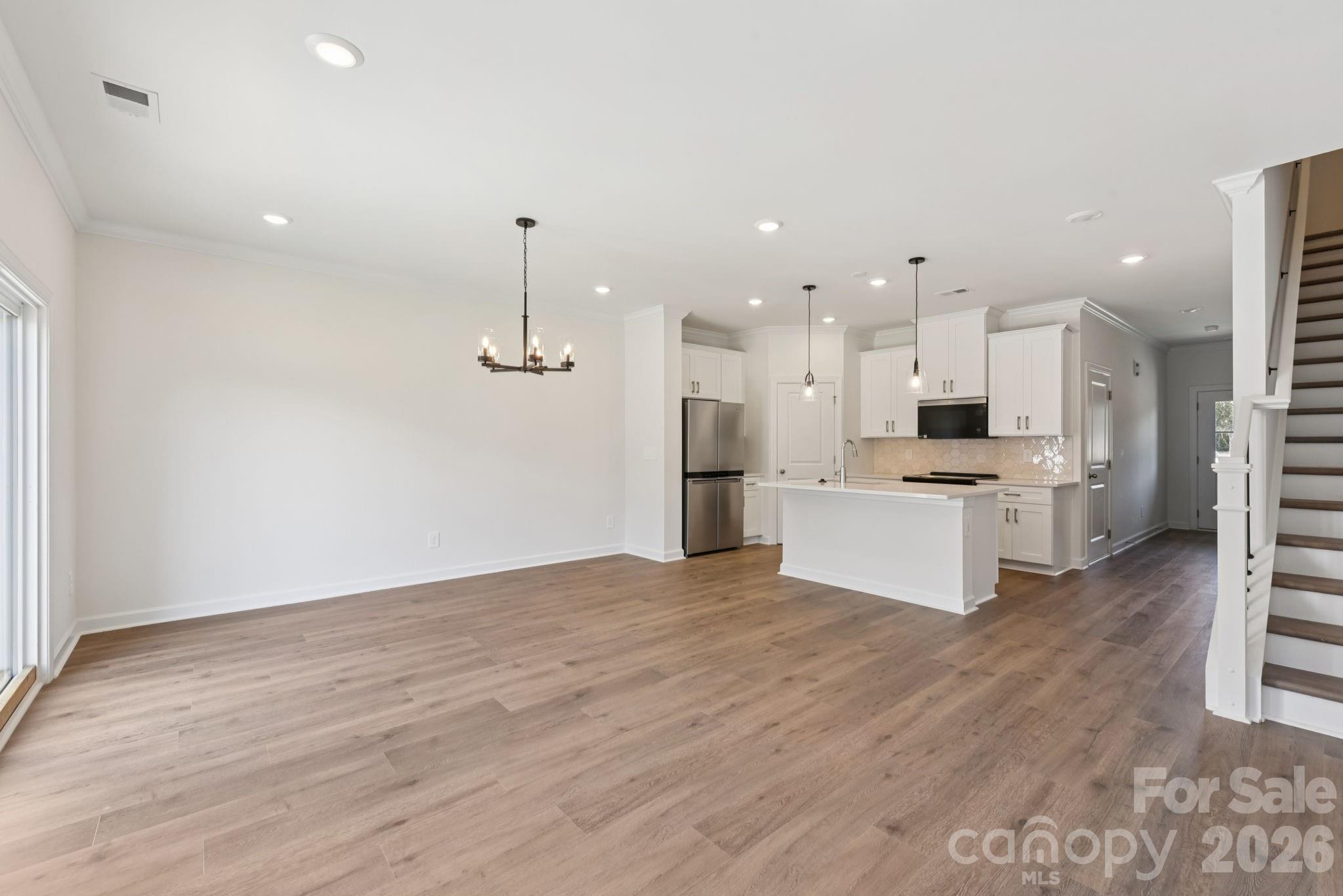 445 Markridge Loop Fort Mill, SC 29708 - Photo 3 of 13 a large white kitchen with kitchen island a sink stainless steel appliances and cabinets