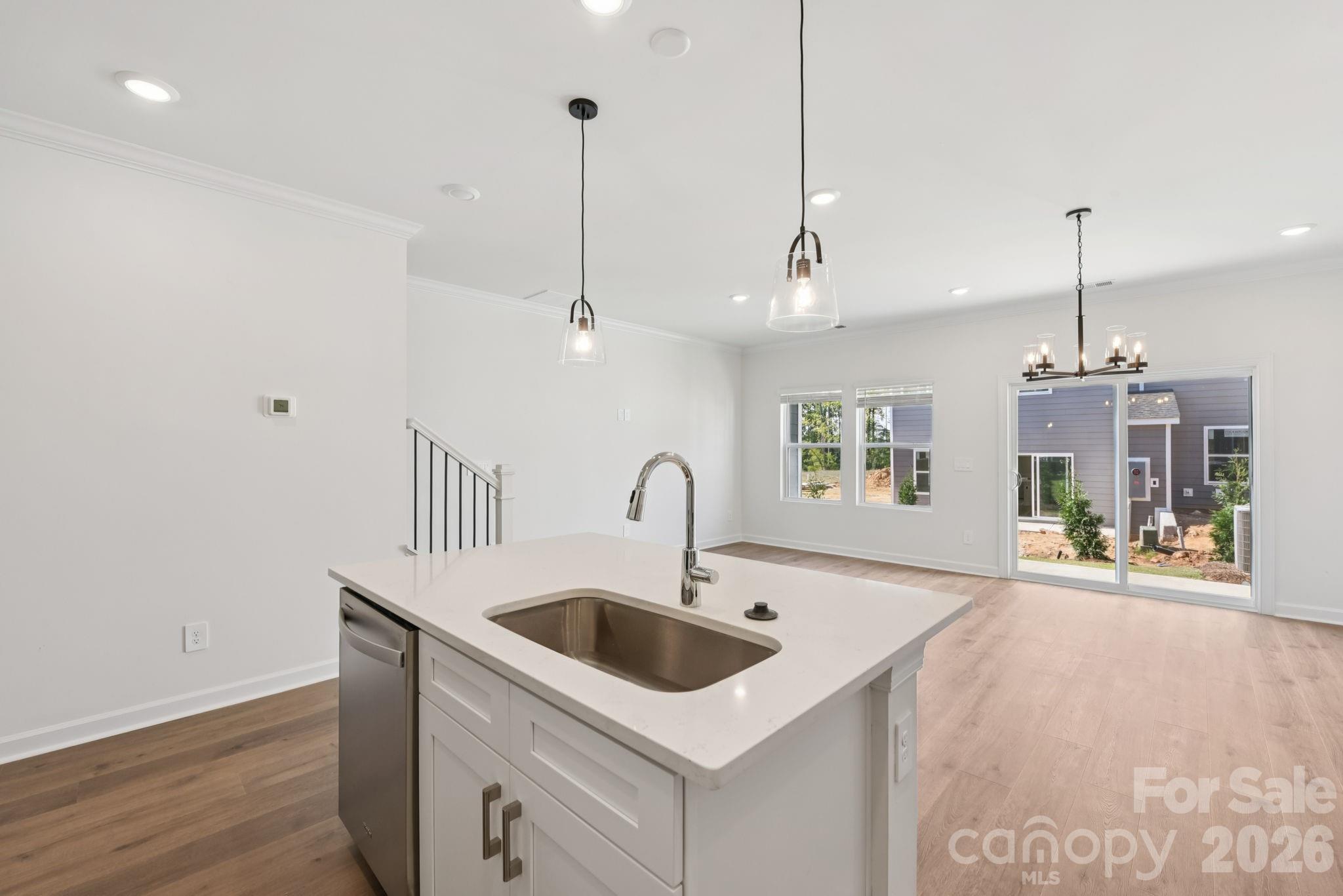 445 Markridge Loop Fort Mill, SC 29708 - Photo 6 of 13 a kitchen with a sink a counter space and a chandelier