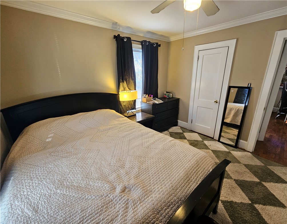 237 Pine Lane Anderson, SC 29621 - Photo 17 of 23 This cozy bedroom features comfortable flooring and crown molding, creating a welcoming and elegant atmosphere.