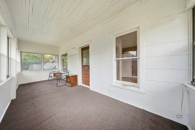 a view of a livingroom with wooden floor and furniture