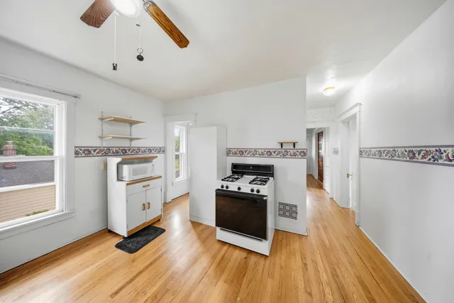 a kitchen with wooden floors and appliances