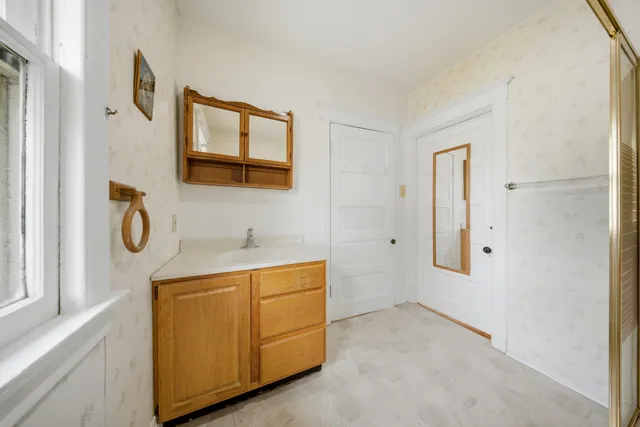 a bathroom with a sink and a mirror