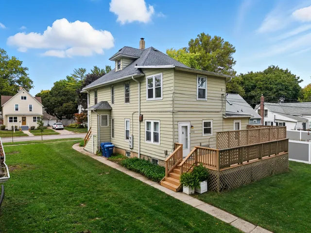 a aerial view of a house with a yard and sitting area