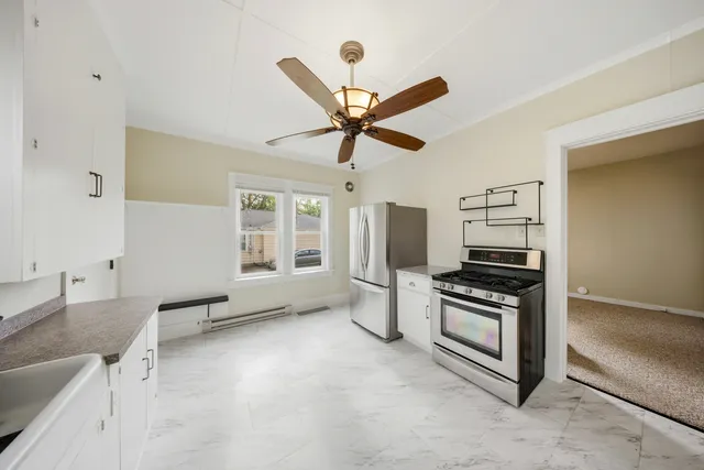 a kitchen with stainless steel appliances a stove a refrigerator sink and cabinets