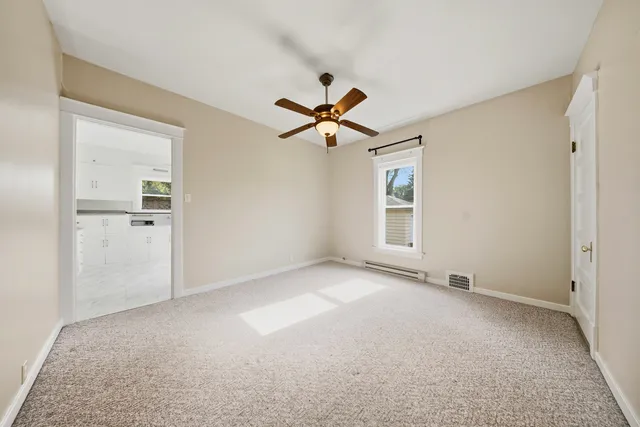 an empty room with closet and windows